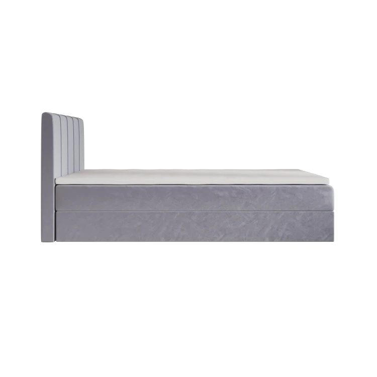 Seitenansicht eines minimalistischen grauen Boxspringbettes.