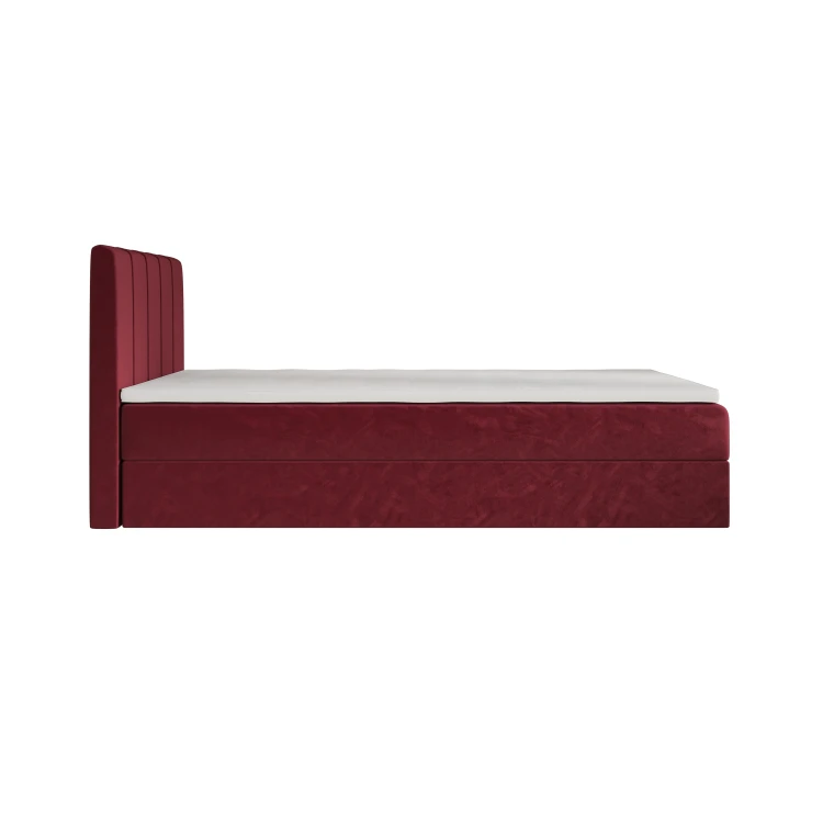 Rotes Boxspringbett aus Samt, Seitenansicht mit weißer Matratze.