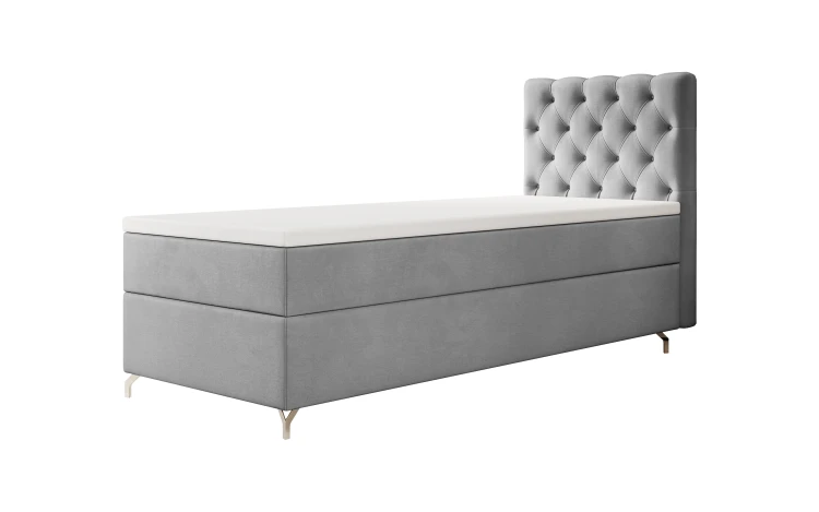 Hellgraues Einzel-Boxspringbett mit silbernen Winkelfüßen auf weiß.